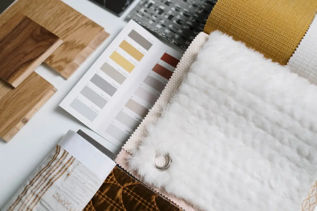 Fabric swatches, timber samples and colour cards laid out for a client consultation